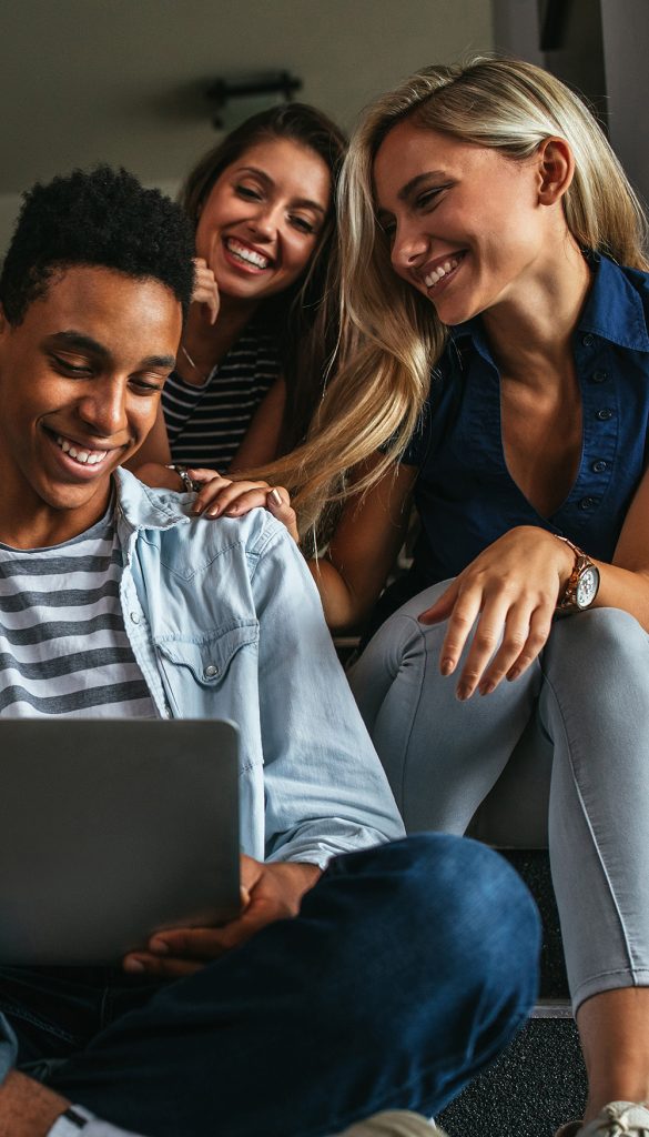 Person on computer being congratulated by friends.